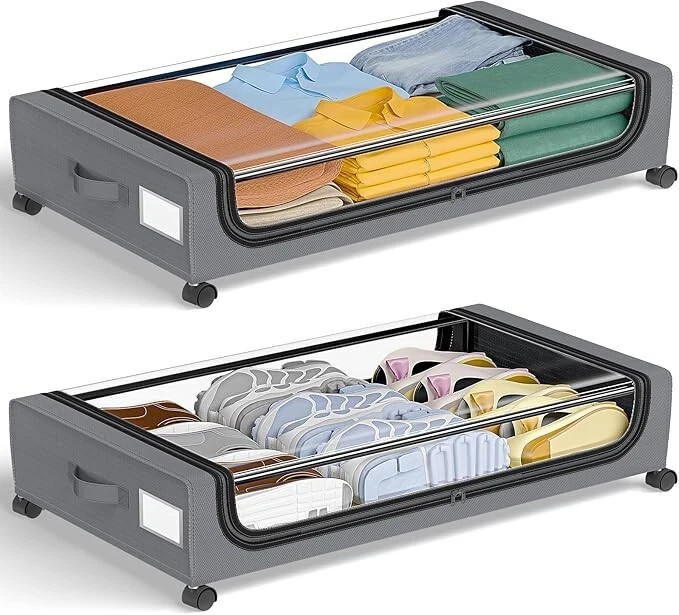 Two grey under-bed storage bags with clear lids holding folded clothes and shoes